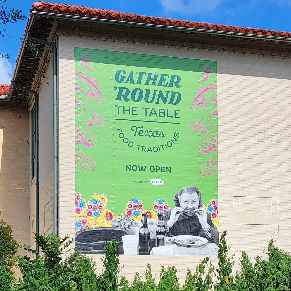 Gather 'Round the Table Mural Green exterior mural advertising the Gather 'Round the Table: Texas Food Traditions exhibit.