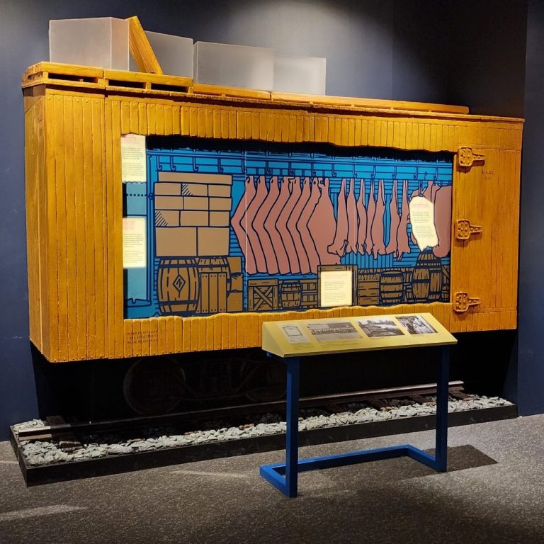 Ice Reefer Car Exhibit Half-scale wooden railcar exhibit with a cutaway side, display track, and interpretive panel.